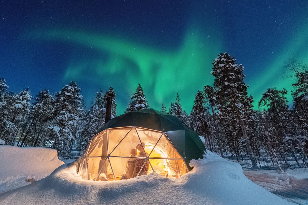Glass igloo under the northern lights
